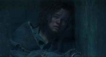 Movie still from “Catch Me If You Can” (2002), directed by Steven Spielberg – A man with long dark hair is looking at the camera; Close Up shot, Low angle