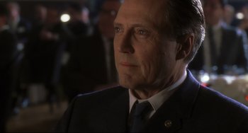 Movie still from “Catch Me If You Can” (2002), directed by Steven Spielberg – A person wearing a suit and tie; Close Up shot, Over the shoulder angle