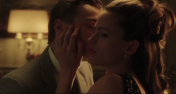 Movie still from “Catch Me If You Can” (2002), directed by Steven Spielberg – A man and a woman are kissing in a room; Close Up shot, Low angle