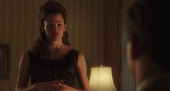 Movie still from “Catch Me If You Can” (2002), directed by Steven Spielberg – A beautiful woman standing in front of a mirror; Medium shot, Over the shoulder angle