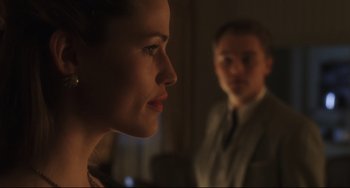 Movie still from “Catch Me If You Can” (2002), directed by Steven Spielberg – A man and a woman are looking at each other in the dark; Close Up shot, Over the shoulder angle