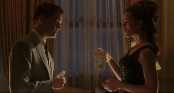 Movie still from “Catch Me If You Can” (2002), directed by Steven Spielberg – A man and a woman are playing a video game together; Medium shot, Low angle