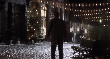 Movie still from “Catch Me If You Can” (2002), directed by Steven Spielberg – A man standing in front of a christmas tree; Extreme Wide shot, Low angle