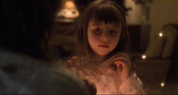 Movie still from “Catch Me If You Can” (2002), directed by Steven Spielberg – A little girl holding a cigarette in her mouth; Close Up shot, Over the shoulder angle