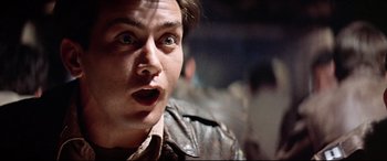 Movie still from “Catch-22” (1970), directed by Mike Nichols – A person wearing a leather jacket; Close Up shot, Low angle