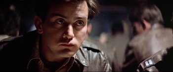 Movie still from “Catch-22” (1970), directed by Mike Nichols – A person wearing a leather jacket; Close Up shot, Low angle