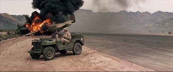Movie still from “Catch-22” (1970), directed by Mike Nichols – Two men sitting in the back of an army vehicle; Wide shot, High angle