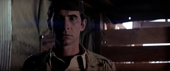 Movie still from “Catch-22” (1970), directed by Mike Nichols – A man in a military uniform looking at the camera; Close Up shot, Low angle