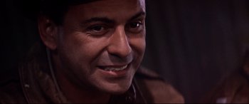 Movie still from “Catch-22” (1970), directed by Mike Nichols – A man smiling for the camera; Close Up shot, Low angle