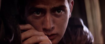 Movie still from “Catch-22” (1970), directed by Mike Nichols – A person with his hand to his face; Extreme Close Up shot, Low angle
