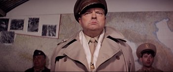 Movie still from “Catch-22” (1970), directed by Mike Nichols – A man wearing a uniform and a hat; Close Up shot, Low angle