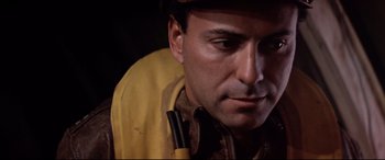 Movie still from “Catch-22” (1970), directed by Mike Nichols – A person wearing a hat and a jacket; Close Up shot, Low angle