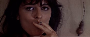 Movie still from “Catch-22” (1970), directed by Mike Nichols – A person holding a cigarette in her mouth; Close Up shot, Low angle