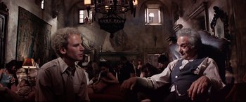 Movie still from “Catch-22” (1970), directed by Mike Nichols – A group of people sitting in a room; Medium shot, Low angle