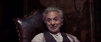 Movie still from “Catch-22” (1970), directed by Mike Nichols – An older man with a gray beard and a mustache; Close Up shot, High angle