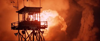 Movie still from “Catch-22” (1970), directed by Mike Nichols – A fire hydrant is burning in the middle of the night; Extreme Wide shot, Low angle