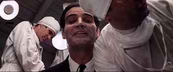 Movie still from “Catch-22” (1970), directed by Mike Nichols – A person wearing a suit and a tie; Close Up shot, Low angle