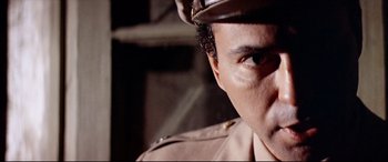 Movie still from “Catch-22” (1970), directed by Mike Nichols – A person wearing a uniform; Close Up shot, Low angle