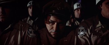 Movie still from “Catch-22” (1970), directed by Mike Nichols – A person wearing a uniform; Close Up shot, Low angle