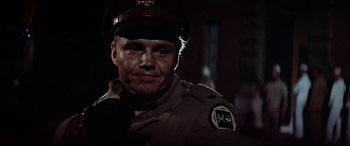 Movie still from “Catch-22” (1970), directed by Mike Nichols – A person wearing a uniform; Close Up shot, Over the shoulder angle