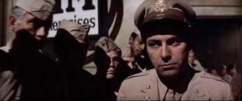 Movie still from “Catch-22” (1970), directed by Mike Nichols – A group of men in military uniforms standing next to each other; Close Up shot, Low angle
