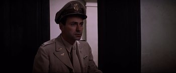 Movie still from “Catch-22” (1970), directed by Mike Nichols – A man in a military uniform wearing a hat; Close Up shot, Low angle