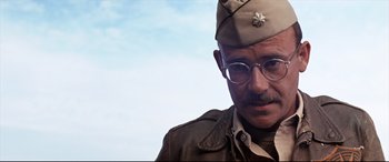 Movie still from “Catch-22” (1970), directed by Mike Nichols – A man in a military uniform with a mustache; Close Up shot, Over the shoulder angle