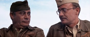 Movie still from “Catch-22” (1970), directed by Mike Nichols – A couple of men in military uniforms standing next to each other; Close Up shot, Low angle