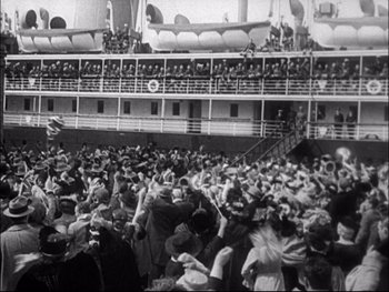 Movie still from “Cavalcade” (1933), directed by Frank Lloyd – A large group of people standing on top of a boat; Extreme Wide shot, High angle