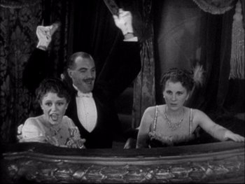 Movie still from “Cavalcade” (1933), directed by Frank Lloyd – A group of people sitting around a mirror; Medium shot, Low angle