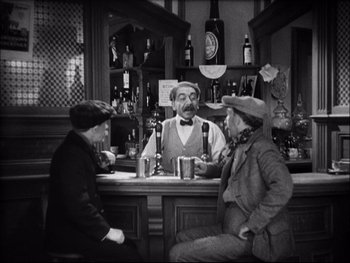 Movie still from “Cavalcade” (1933), directed by Frank Lloyd – A group of people sitting at a bar; Medium shot, High angle