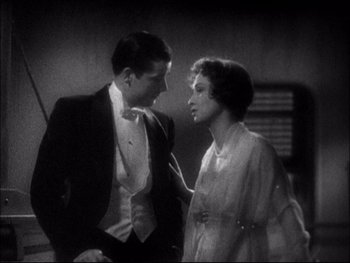 Movie still from “Cavalcade” (1933), directed by Frank Lloyd – A man and a woman standing next to each other; Medium shot, High angle