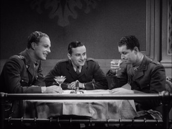 Movie still from “Cavalcade” (1933), directed by Frank Lloyd – A group of men sitting at a table with a drink; Medium shot, High angle
