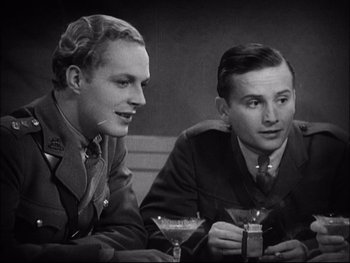 Movie still from “Cavalcade” (1933), directed by Frank Lloyd – A couple of men sitting next to each other at a table; Close Up shot, High angle