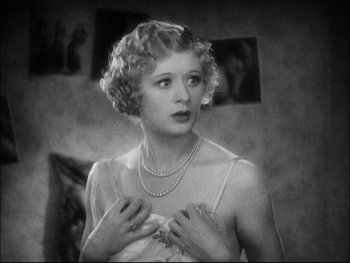 Movie still from “Cavalcade” (1933), directed by Frank Lloyd – An old black and white photo of a woman in a negligee; Close Up shot, High angle