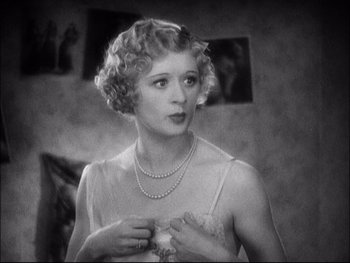 Movie still from “Cavalcade” (1933), directed by Frank Lloyd – An old photo of a woman in a white dress; Close Up shot, High angle