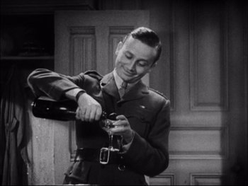 Movie still from “Cavalcade” (1933), directed by Frank Lloyd – An old photo of a man opening a bottle of wine; Medium shot, Low angle