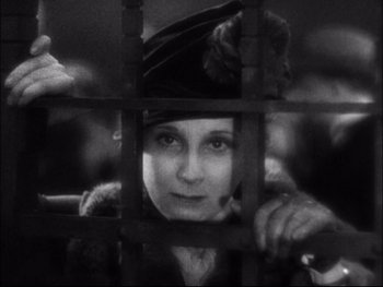 Movie still from “Cavalcade” (1933), directed by Frank Lloyd – An old photo of a woman looking through a fence; Close Up shot, Low angle