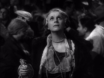 Movie still from “Cavalcade” (1933), directed by Frank Lloyd – An old photo of a woman looking up at the sky; Close Up shot, Low angle