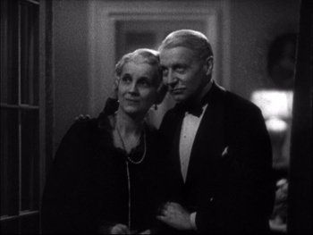 Movie still from “Cavalcade” (1933), directed by Frank Lloyd – An older man and woman posing for a picture; Close Up shot, Low angle