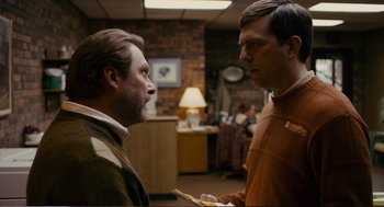 Movie still from “Cedar Rapids” (2011), directed by Miguel Arteta – Two men are talking in an office setting; Medium shot, Over the shoulder angle