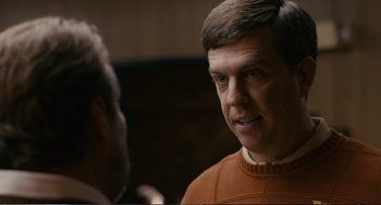Movie still from “Cedar Rapids” (2011), directed by Miguel Arteta – A man wearing a sweater talking to another man; Close Up shot, Over the shoulder angle
