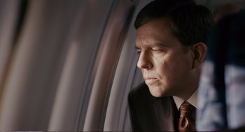 Movie still from “Cedar Rapids” (2011), directed by Miguel Arteta – A person wearing a suit and tie; Close Up shot, Over the shoulder angle