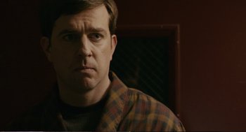 Movie still from “Cedar Rapids” (2011), directed by Miguel Arteta – A person wearing a plaid shirt; Close Up shot, Over the shoulder angle