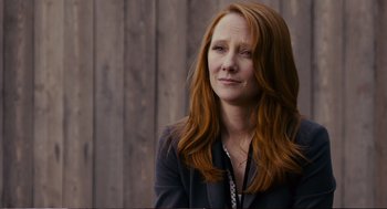 Movie still from “Cedar Rapids” (2011), directed by Miguel Arteta – A woman with long red hair wearing a black jacket; Close Up shot, Over the shoulder angle