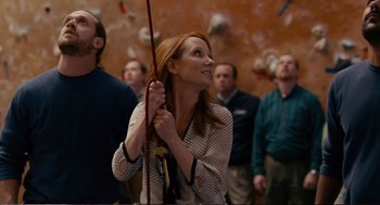 Movie still from “Cedar Rapids” (2011), directed by Miguel Arteta – A group of people standing in front of a rock wall; Medium shot, Low angle