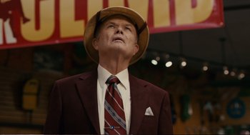 Movie still from “Cedar Rapids” (2011), directed by Miguel Arteta – An older man in a suit and hat looking up; Close Up shot, Low angle