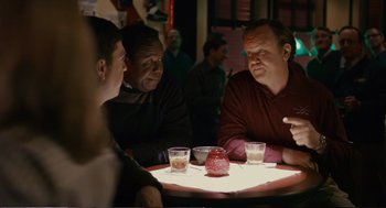 Movie still from “Cedar Rapids” (2011), directed by Miguel Arteta – A group of people sitting at a table with drinks; Medium shot, Over the shoulder angle