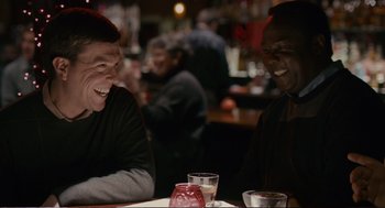 Movie still from “Cedar Rapids” (2011), directed by Miguel Arteta – Two men are sitting at a table and laughing; Medium shot, Over the shoulder angle