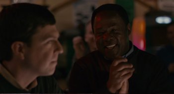 Movie still from “Cedar Rapids” (2011), directed by Miguel Arteta – Two men are talking and laughing at a party; Close Up shot, Over the shoulder angle